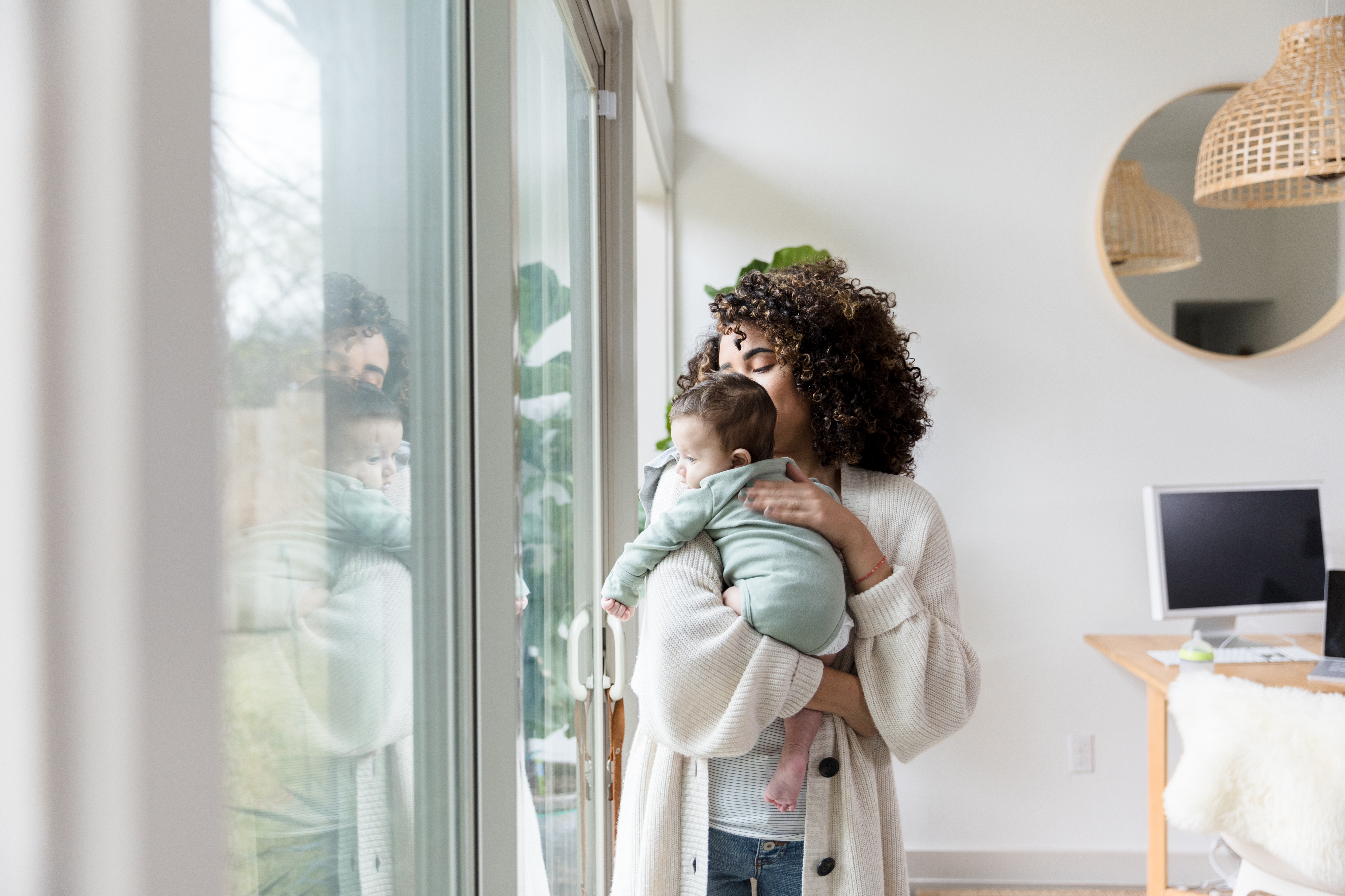 mom holding baby upstairs